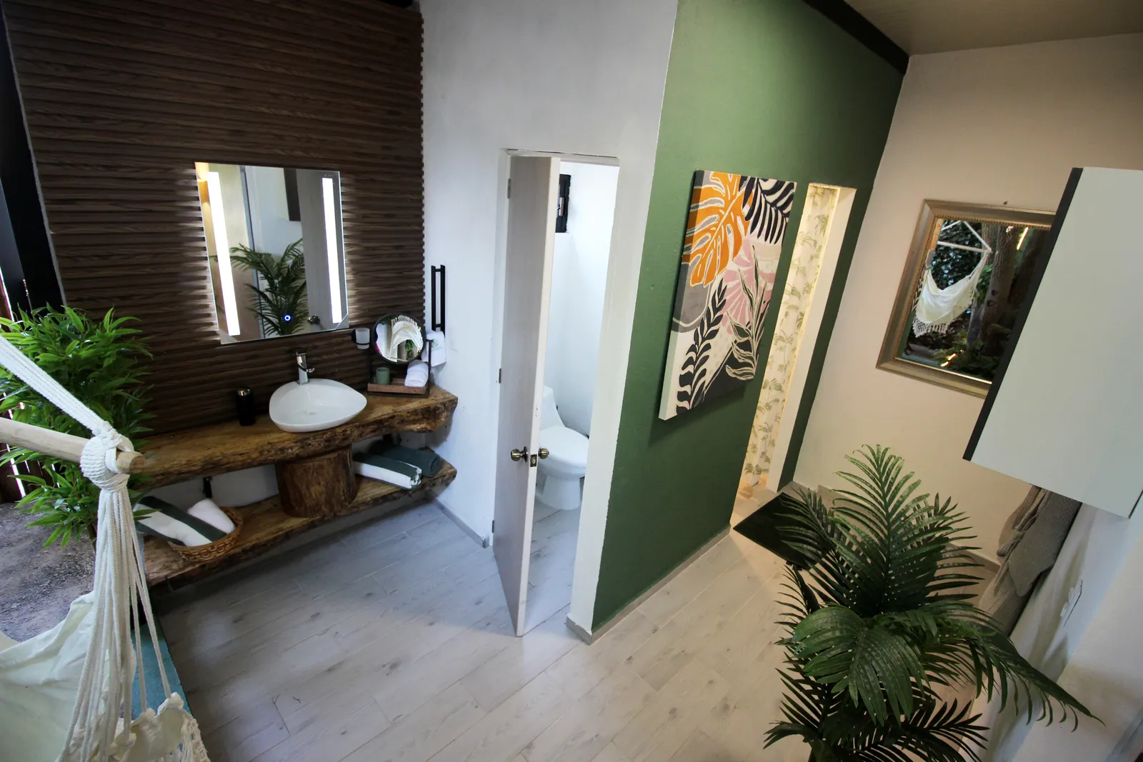 Baño interior de una suite Casa Laureles con detalles en madera y arte botánico